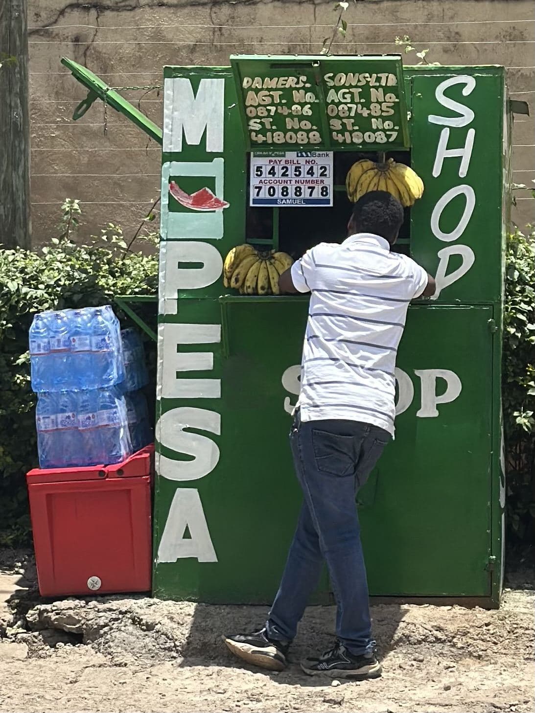 A roadside kiosk in Nairobi with its owner at the counter