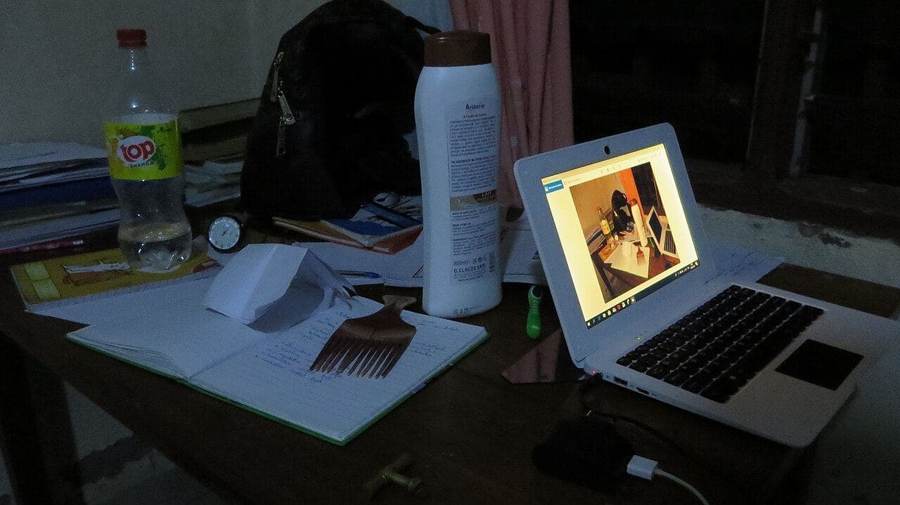 A laptop open on a student’s reading table at night